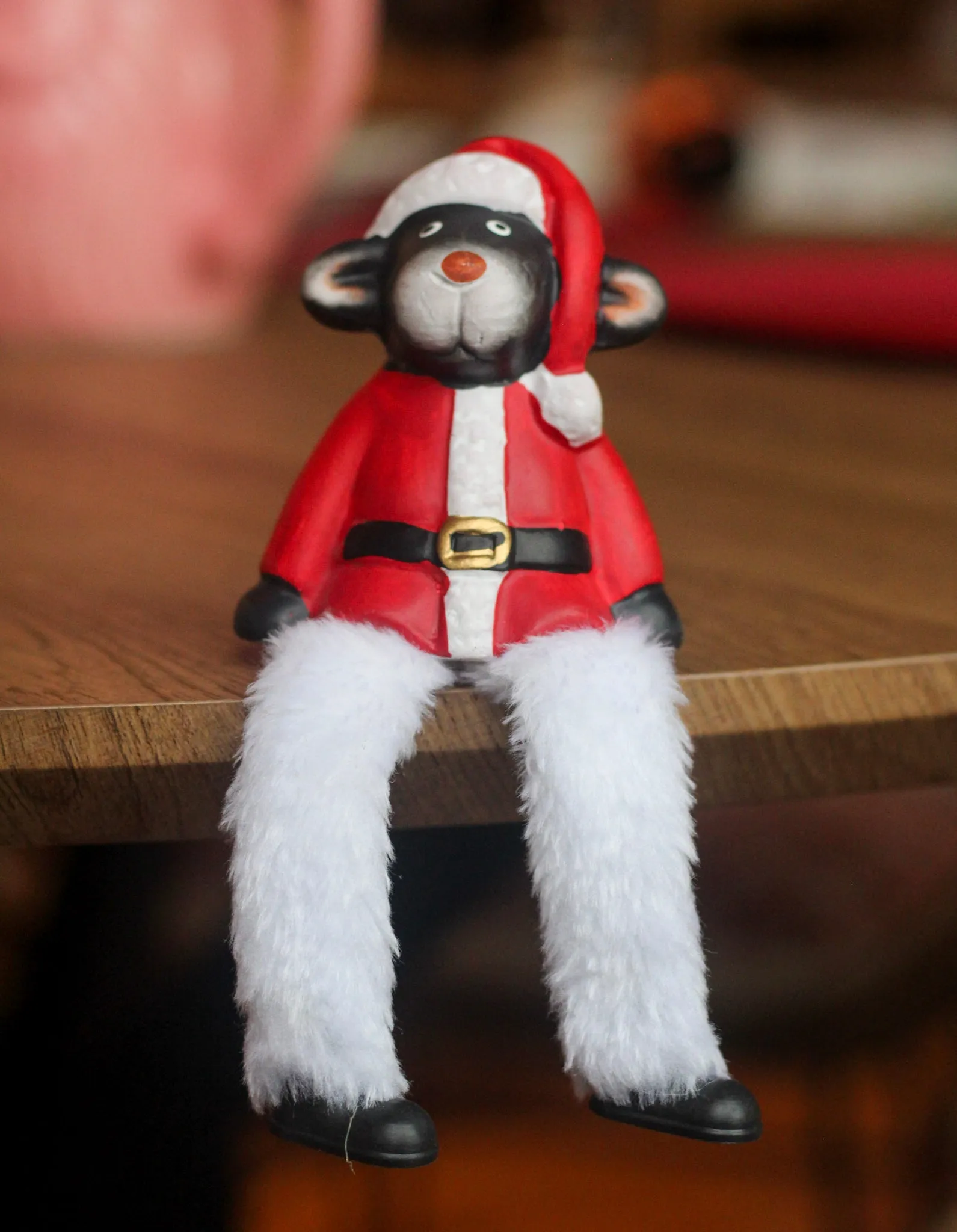 Ceramic Sitting Sheep Ornament With Festive Santa Outfit and Fuzzy Legs